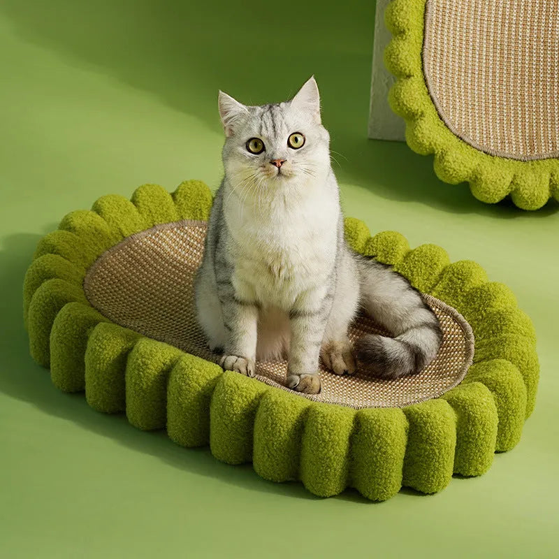 Green oval sisal cat scratching pad serving as a lounging bed with dimensions 650mm by 420mm.