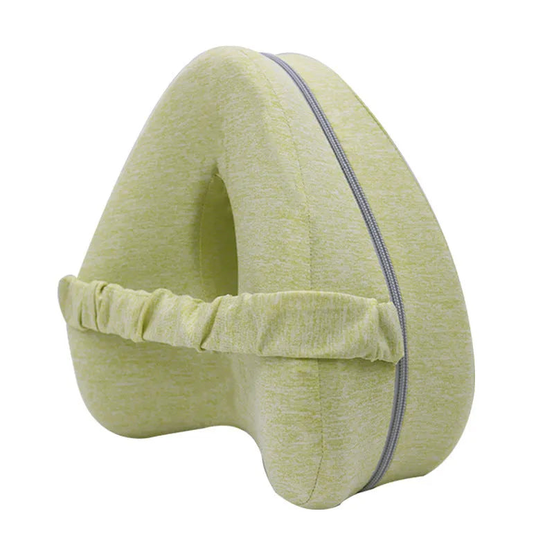 Love heart-shaped dark blue jacquard memory foam leg pillow on a bed.