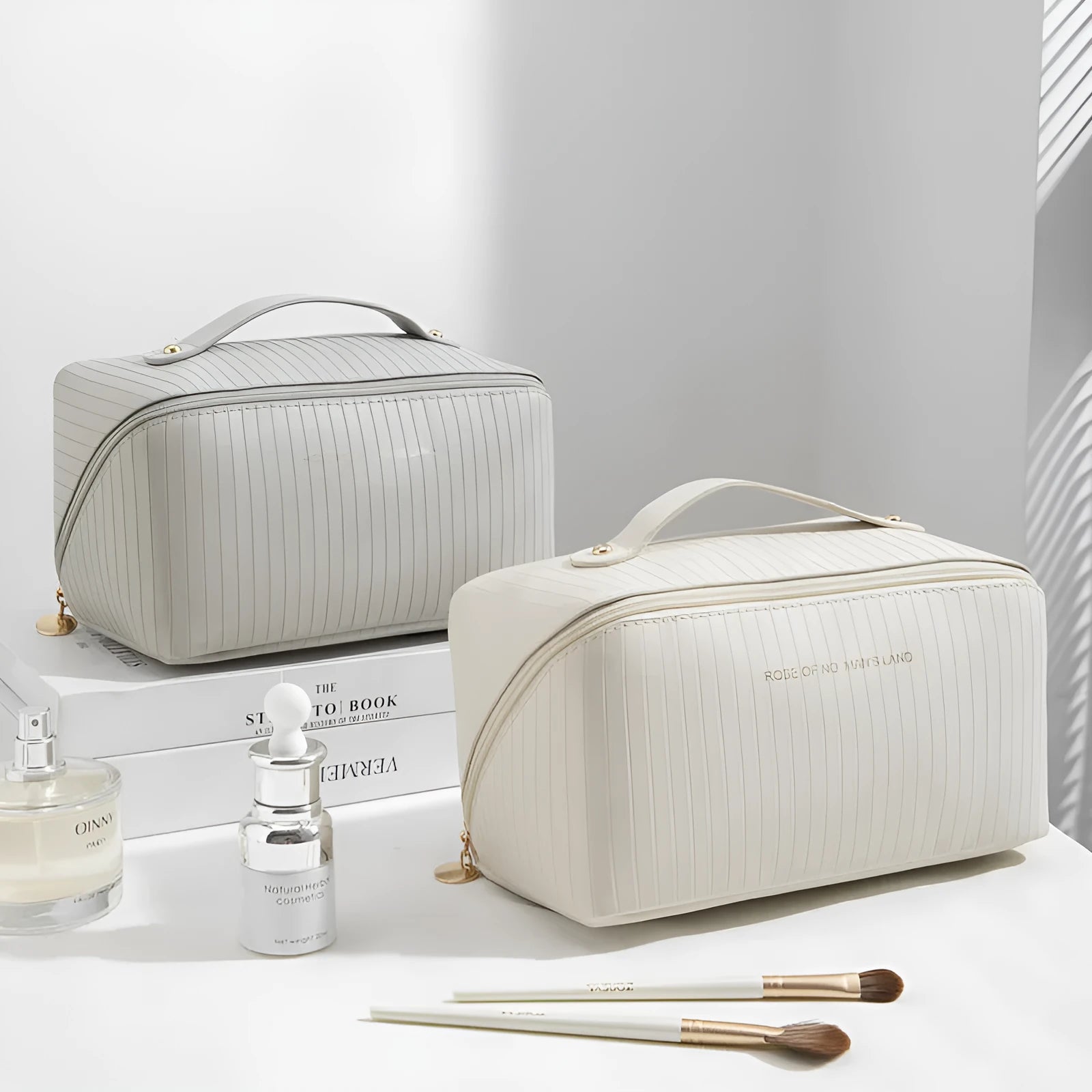 Vertical striped cubic makeup bag in beige with 22.5cm dimensions showing open interior