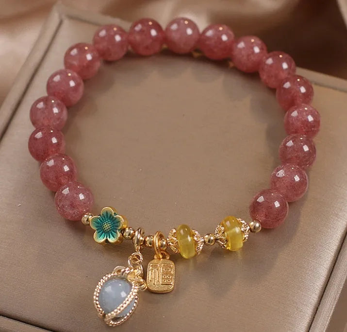 Red strawberry quartz beaded bracelet with alloy charms and rhinestone details for women.