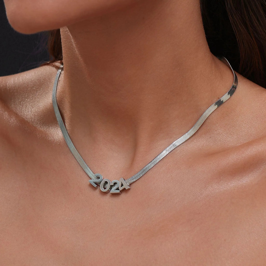 Gold titanium steel necklace with the letter 'A' pendant on a blade chain, 40.5cm long.