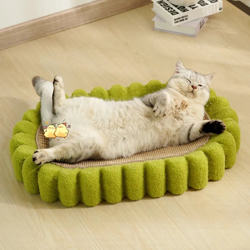 Green oval sisal cat scratching pad serving as a lounging bed with dimensions 650mm by 420mm.