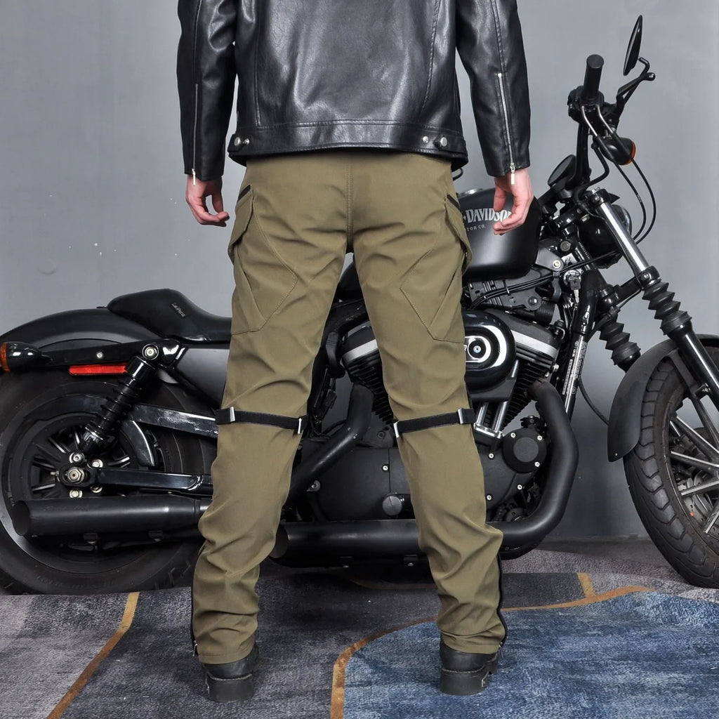 Men's black waterproof motorcycle cycling trousers with belt and protective gear on a hanger.