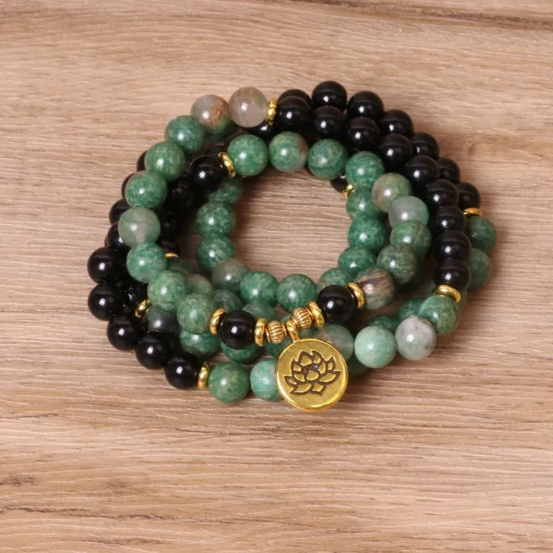 Green and black alloy beaded bracelet on an elastic cord