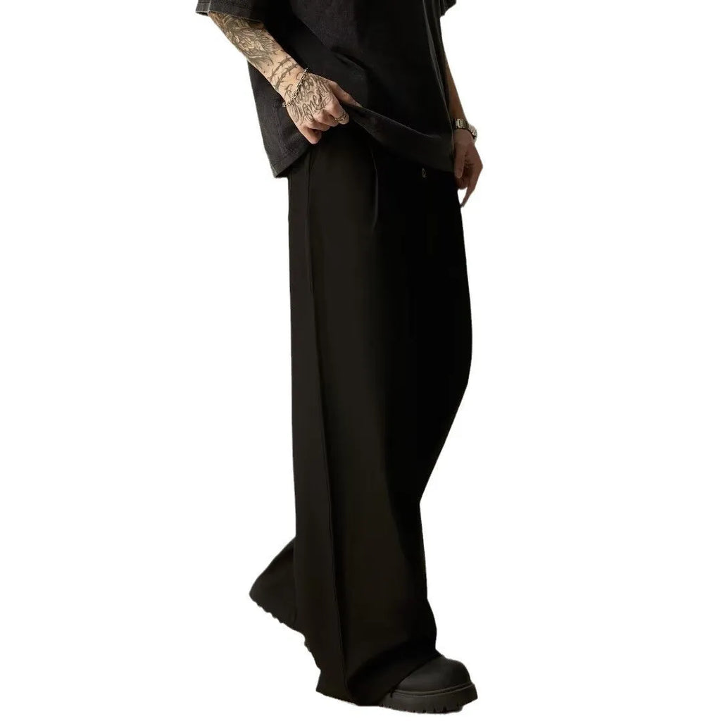 Men's black casual trousers with wide-leg design and button front in polyester cotton blend fabric