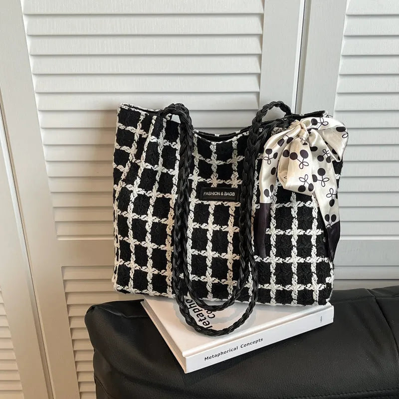 Black wool shoulder bag with horizontal square shape showing interior file compartment and phone pocket