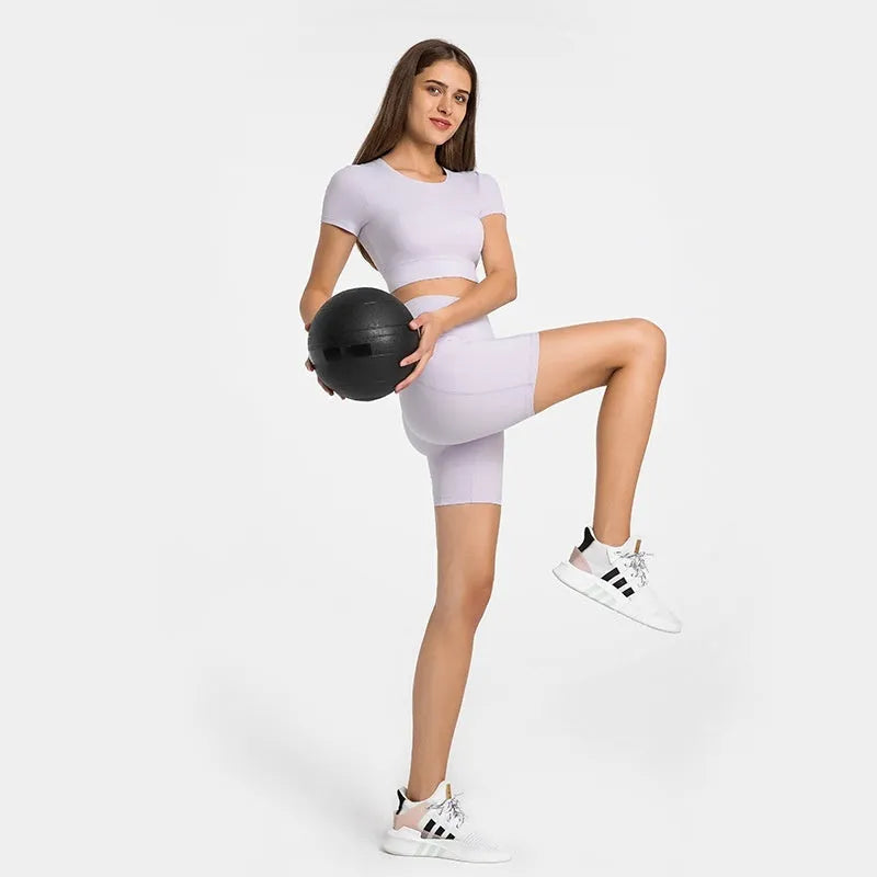 Women's tight-fitting sport shorts in a solid colour, shown on a model for running or gym use.
