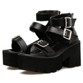 Black women's sandals with chunky heel, thick sole, round toe, buckle detail, and back zipper.