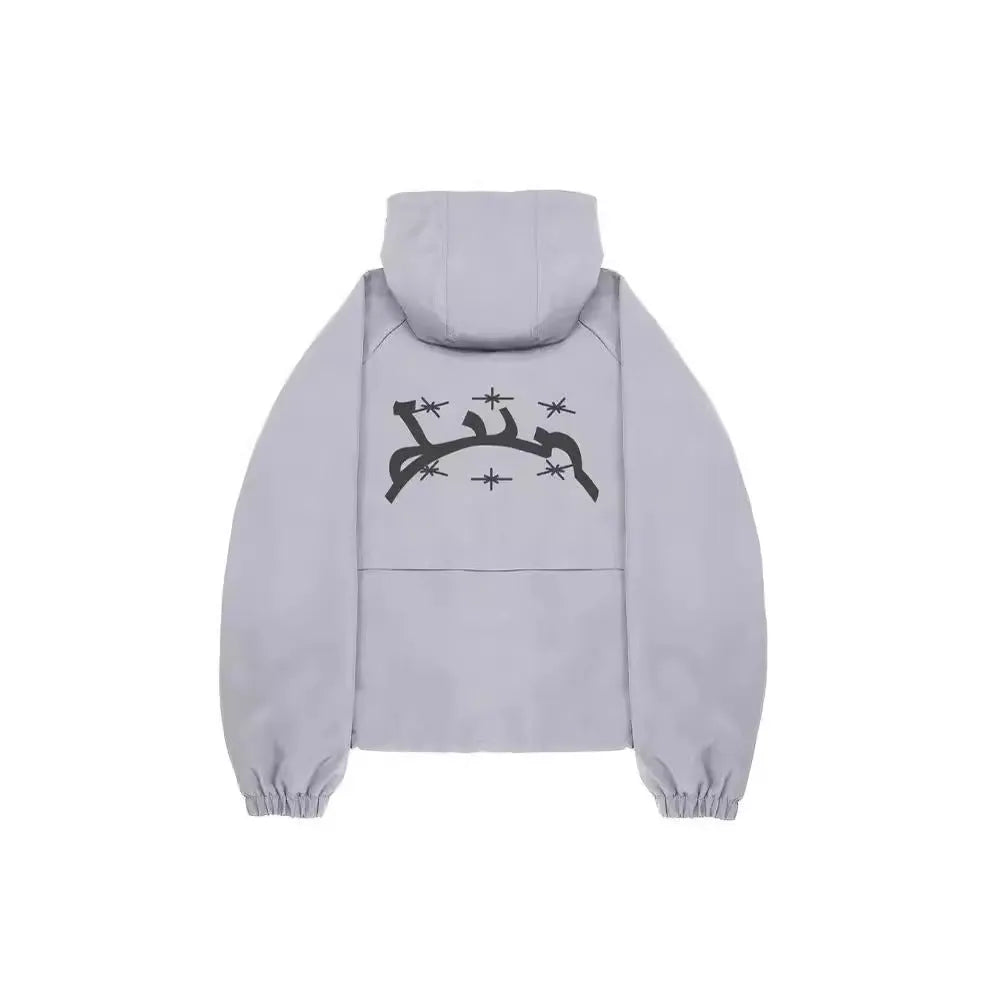 Men's grey hooded sunscreen jacket in British-style loose fit on a middle-aged man outdoors