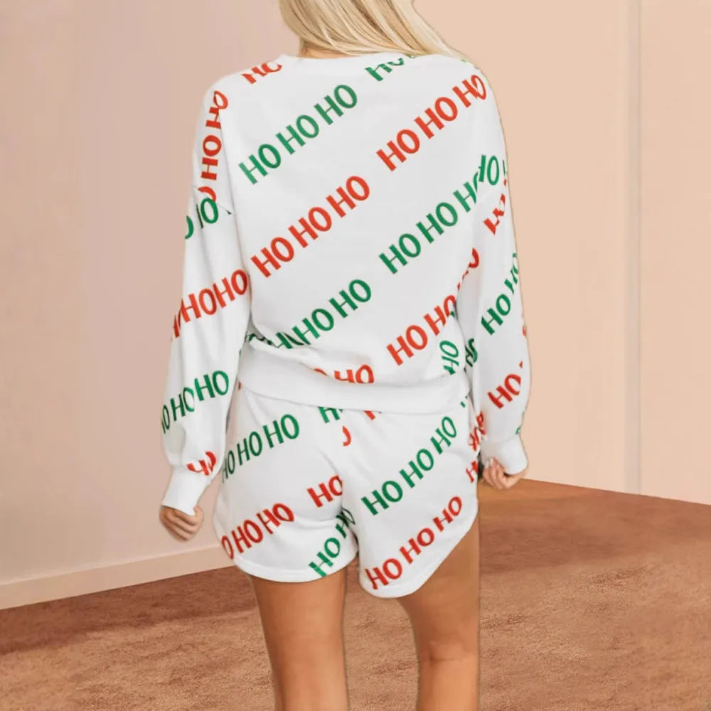 White women's two-piece suit with printed letters on the long-sleeved top and matching trousers.