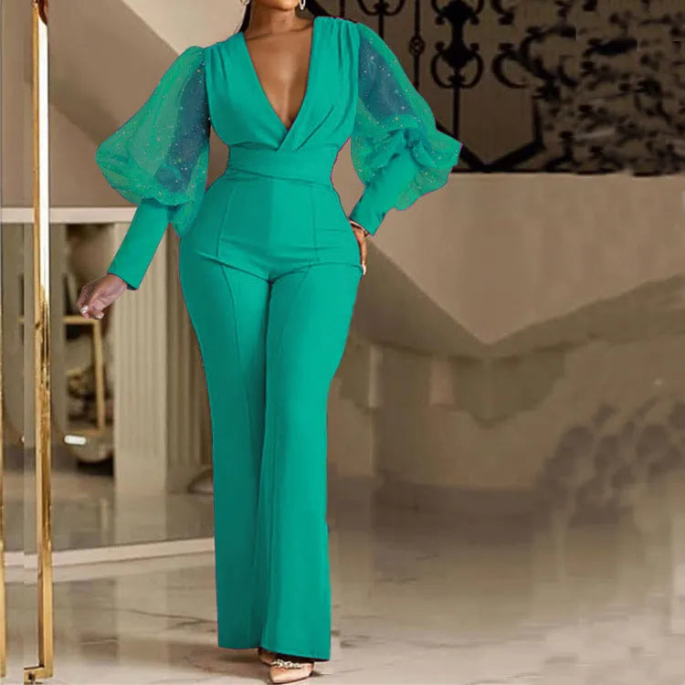 Red women's mesh stitch jumpsuit with long sleeves, wide leg trousers, and an elastic waist.