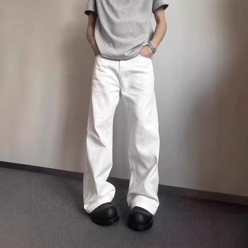 Men's white loose fit straight leg denim jeans on a mid waist with a zipper fly.