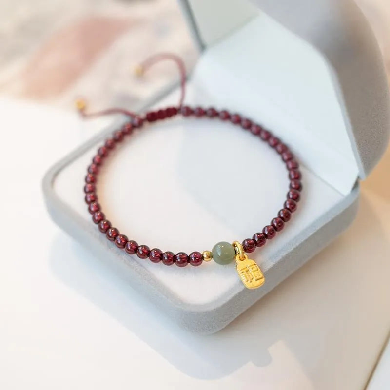 Hand-woven red rope bracelet with strawberry quartz crystal elements in simple women's style