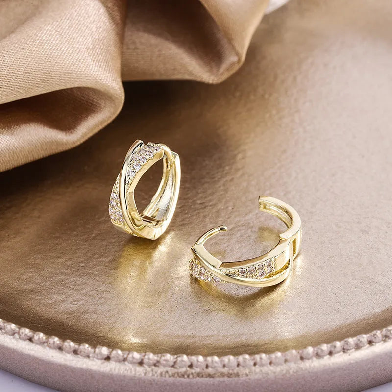 A pair of geometric drop earrings with zircon crystals in a 14K yellow finish.
