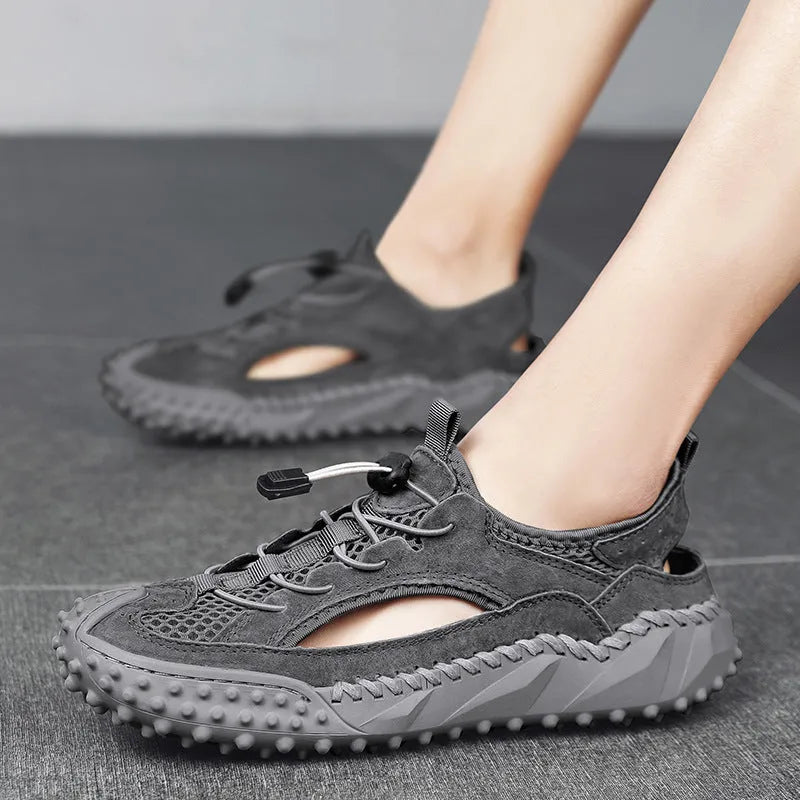 Men's black sports sandals with leather mesh upper and rubber sole showing elastic band fastening