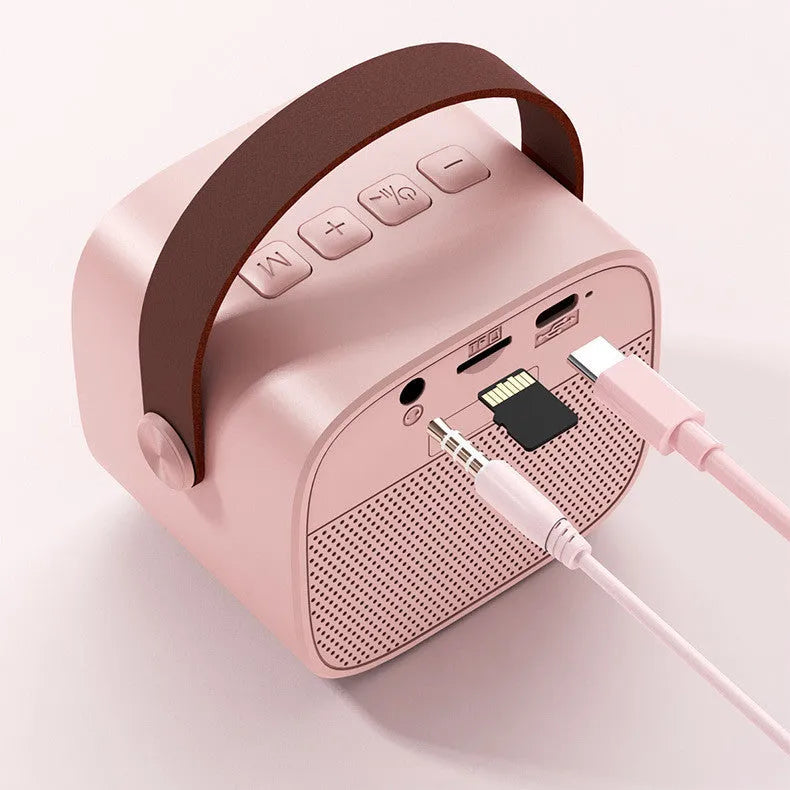 Compact Bluetooth portable speaker with microphone in white, pink, or blue colours showing USB port