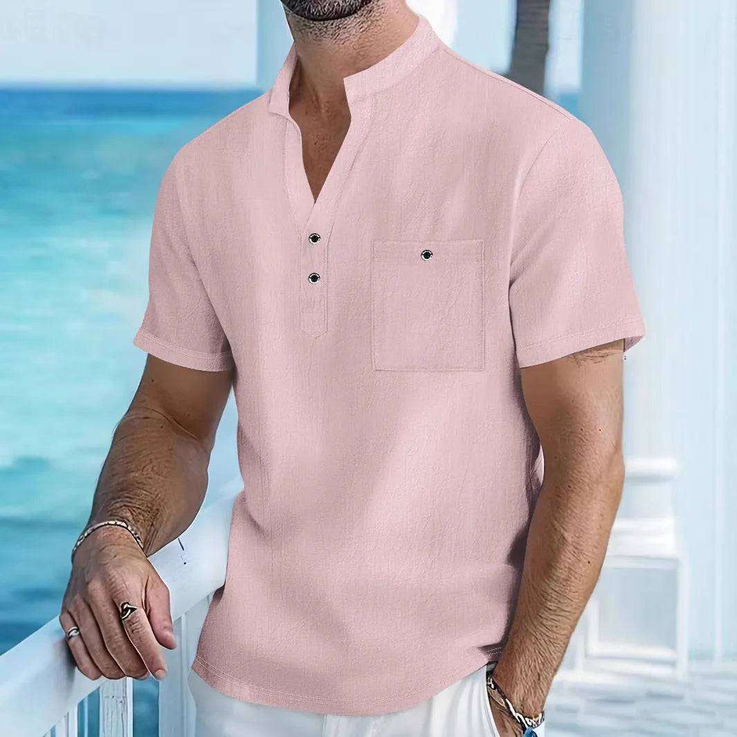Man wearing a light blue stand collar linen short sleeve t-shirt with a loose fit.