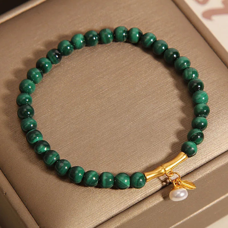 Close-up of a women's adjustable crystal bracelet with a white Lucky Bamboo design on wrist.