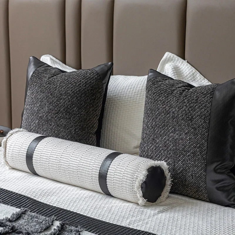 Modern grey and white plaid bed runner blanket set with leather round pillow on a bed