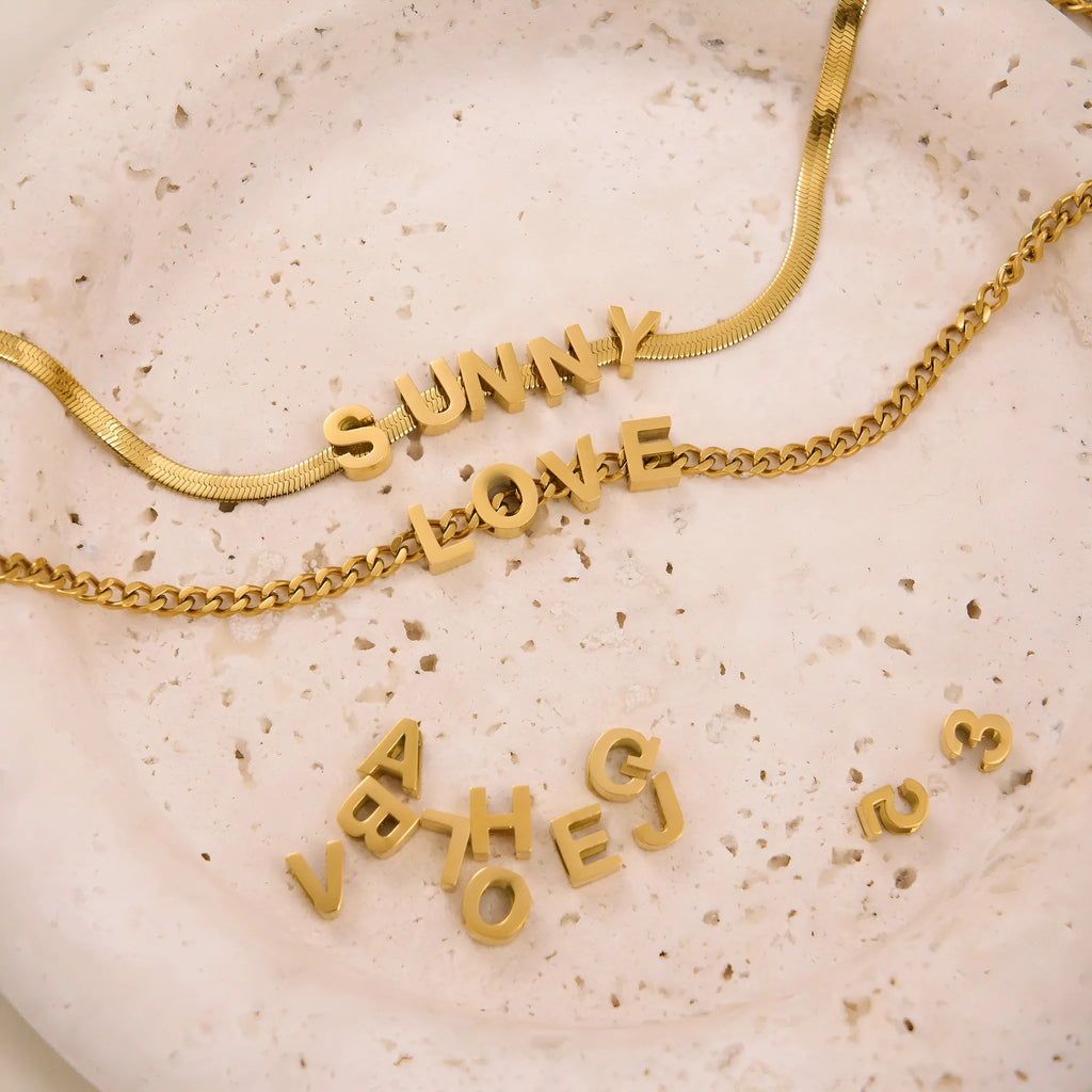 Gold titanium steel necklace with the letter 'A' pendant on a blade chain, 40.5cm long.