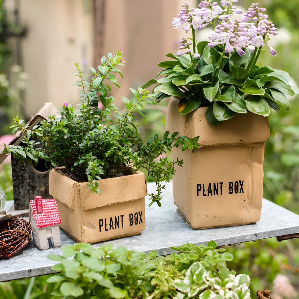 Cement brown paper box style floor planter with a drainage hole, shown in a Nordic indoor setting.