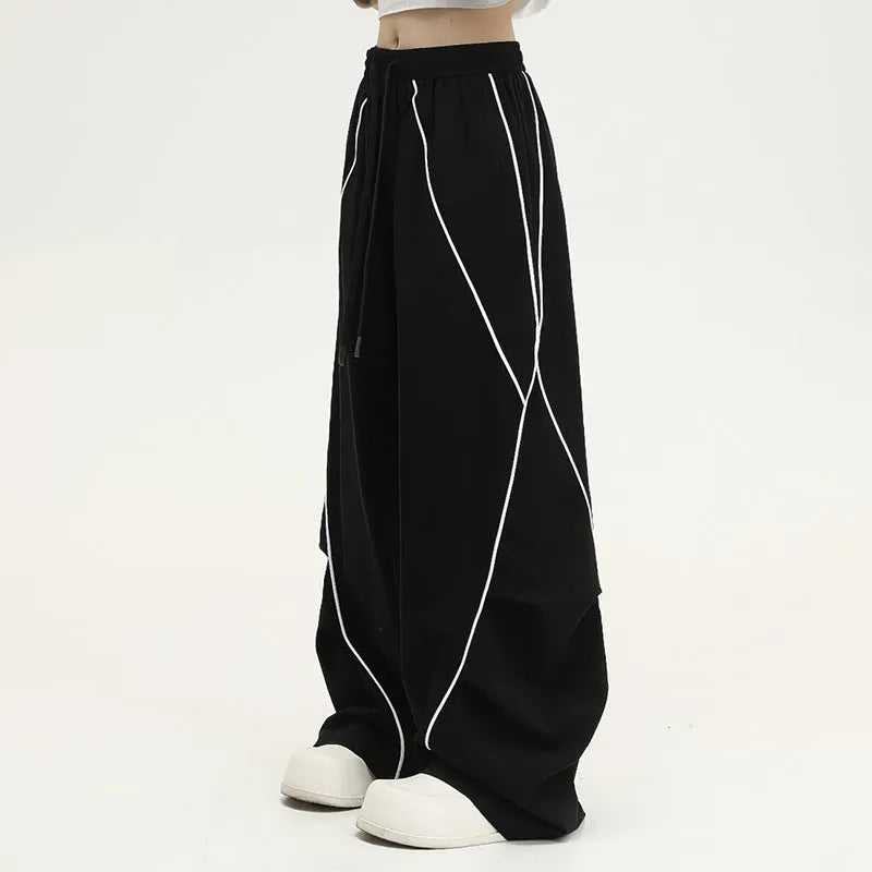 Black pleated wide-leg hip hop sports trousers with a stripe pattern on a mannequin