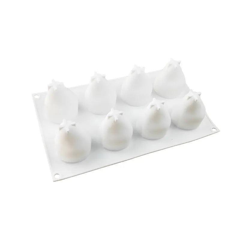Green silicone baking mould with six cavities shaped like pineapples and pine cones.