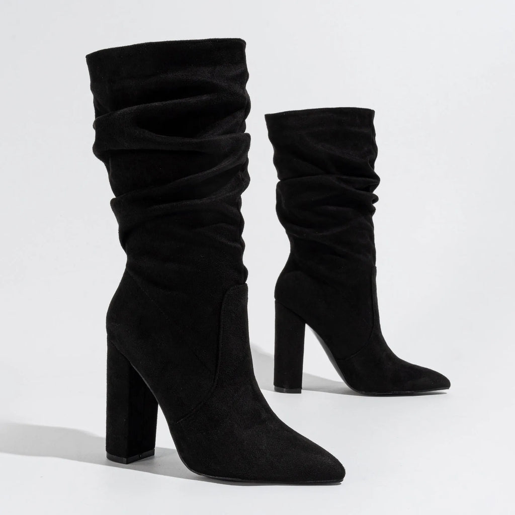 Women's black suede chunky heel boots with pointed toe and calf-length design.
