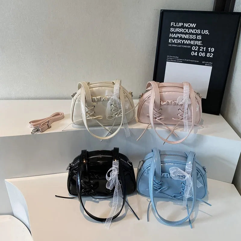 Women's bandage bow handbag in milky white colour with adjustable bow detail and internal mobile phone compartment