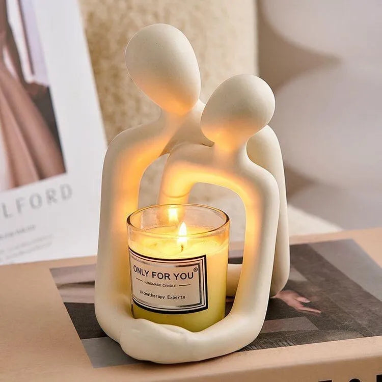 Modern white and gold resin couple statue for shelf or desk decor.