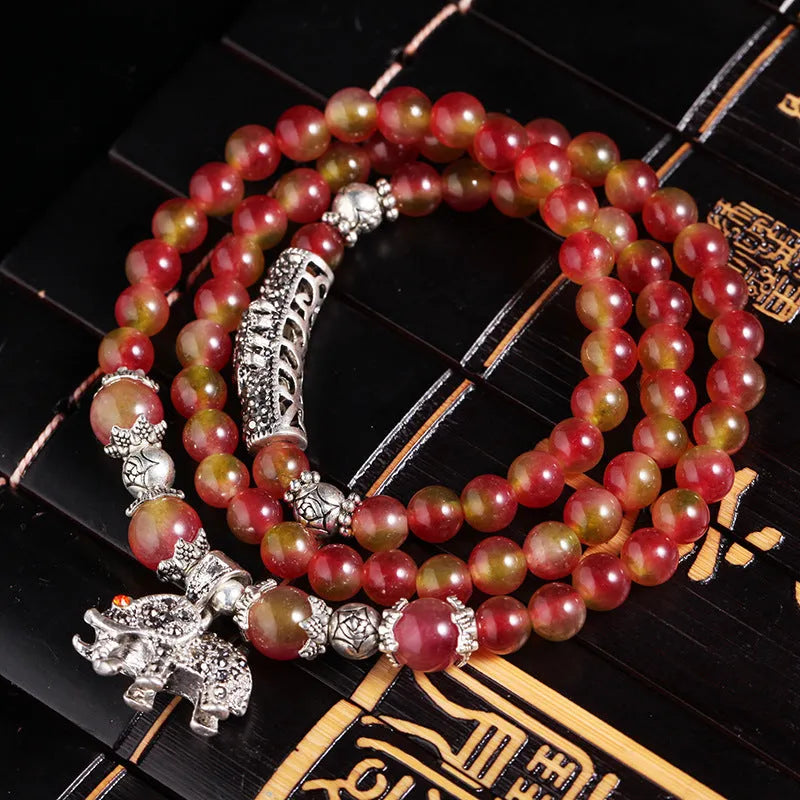 Handmade geometric bracelet made from natural watermelon crystal beads with Chinese knot closure.