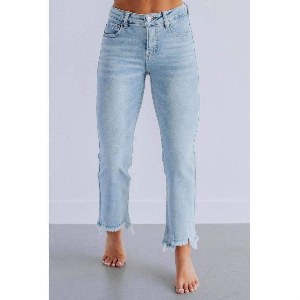 Solid colour women's cotton denim jeans with a hand-distressed finish in dark blue