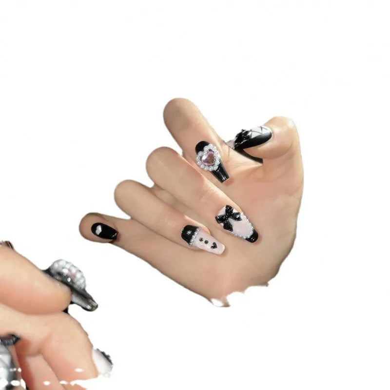 Hand-painted black and pink peach heart false nails with bow designs and cat's eye finish in four sizes
