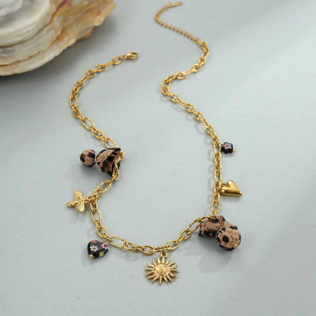 Geometric pendant stainless steel necklace with leopard, love heart and flower designs on adjustable chain