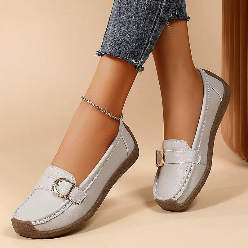Women's casual loafers in beige with round toe, flat heel, and shallow cut opening.