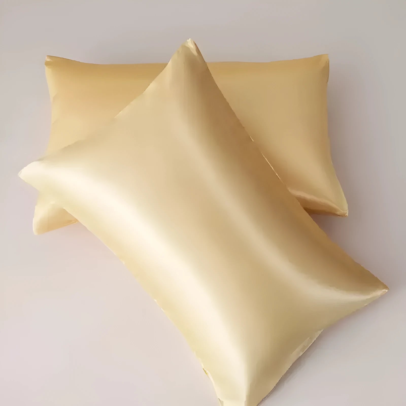 A pair of solid colour satin pillowcases in a chosen colour, showing smooth texture and plain weave fabric.