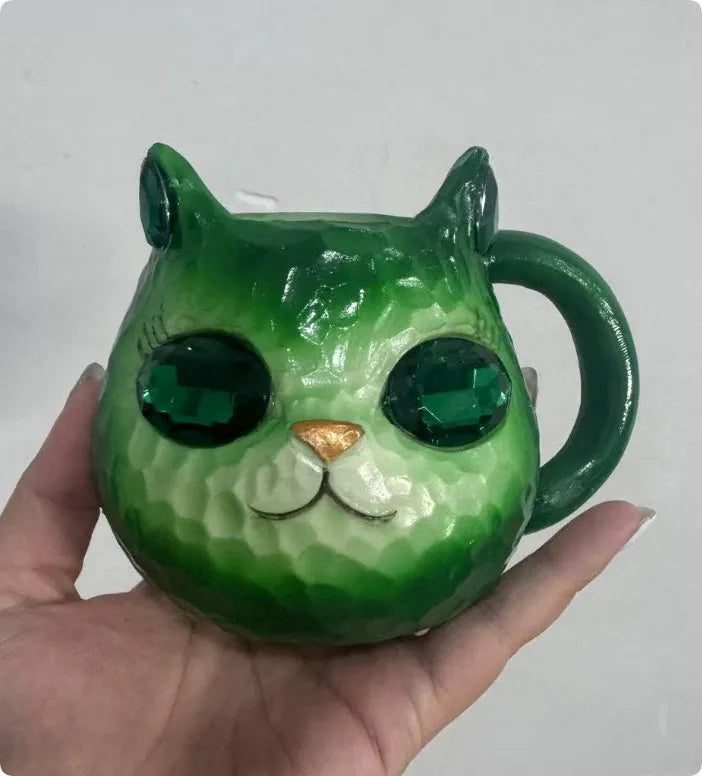 Decorative resin cat cup paperweight in American crafts style, shown in purple, green, blue, and pink colour options.