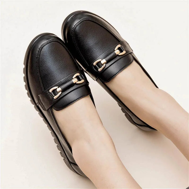 Black women's slip-on pumps with a round toe, low flat heel, and soft rubber sole.