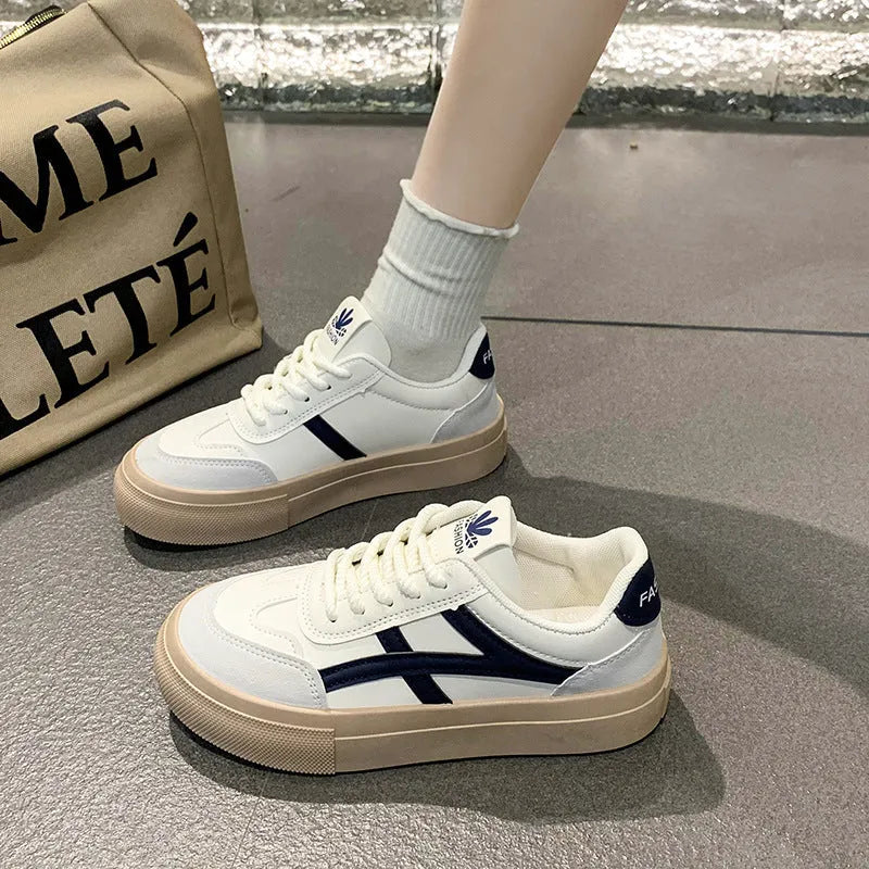 Women's brown and blue lace-up casual trainers with a patent leather-look PU upper and rubber sole.