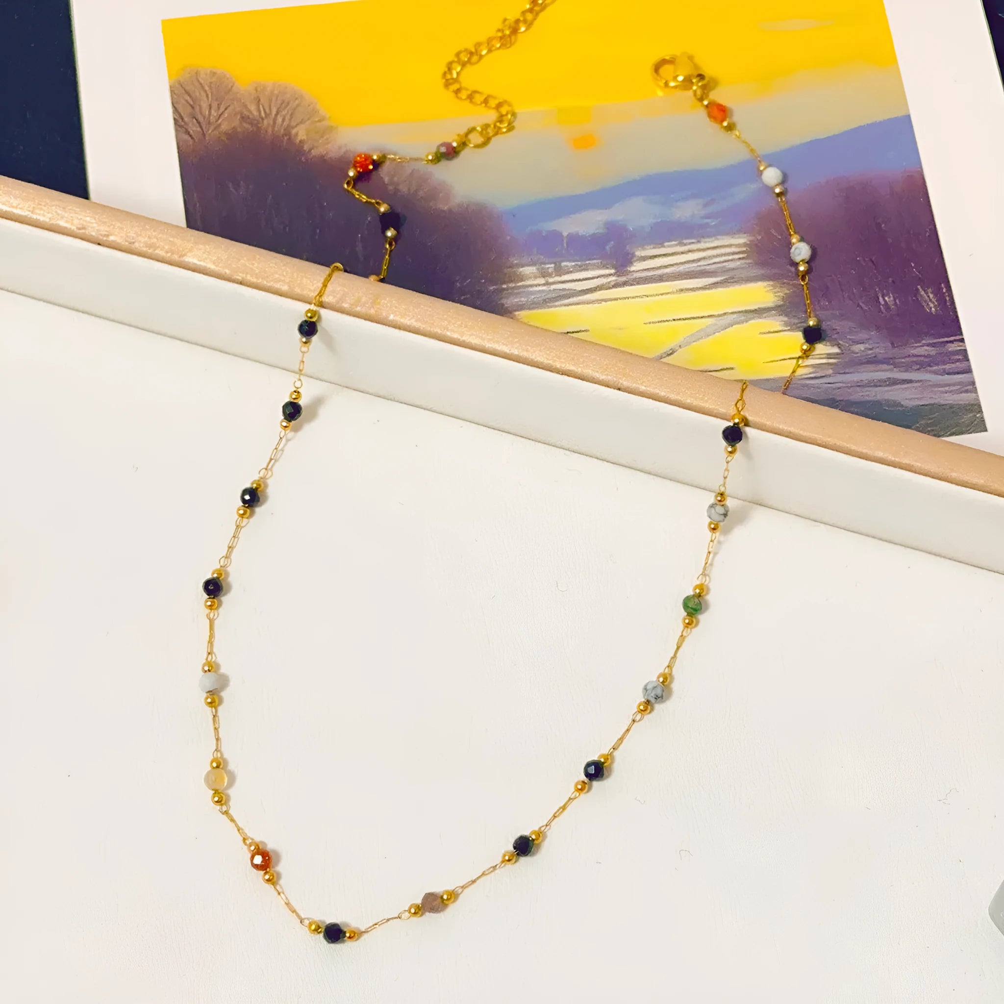 Gold titanium steel women's necklace with a natural stone pendant on an O-ring chain.