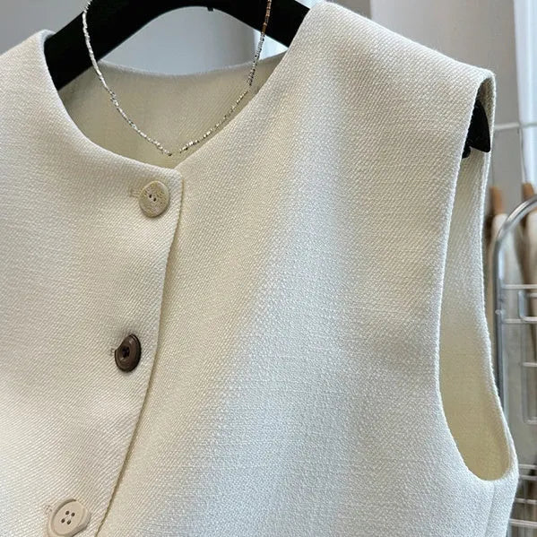 Women's round neck sleeveless vest in milky white, French bandage style, shown front view.
