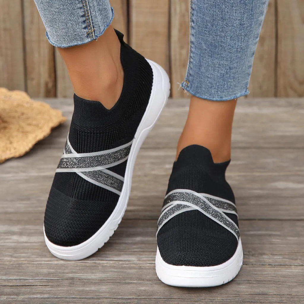 Women's black flat knit mesh shoes with fabric uppers, rubber soles, and tassel detail