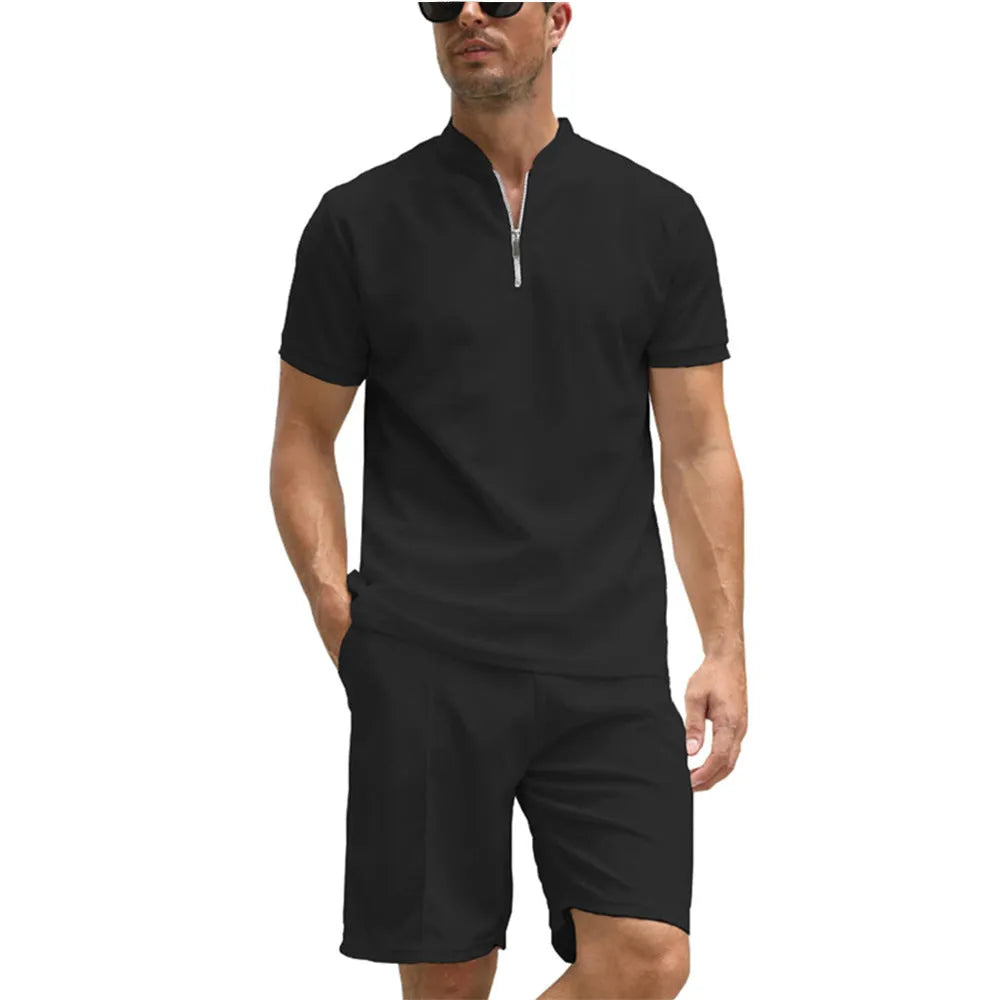 Men's solid colour polo shirt and matching trousers two-piece set on a hanger.