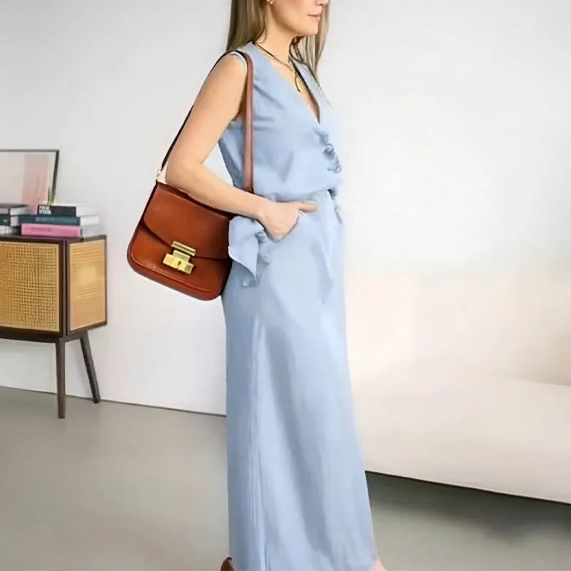 Women's blue polyester two-piece suit with sleeveless vest and long skirt on hanger