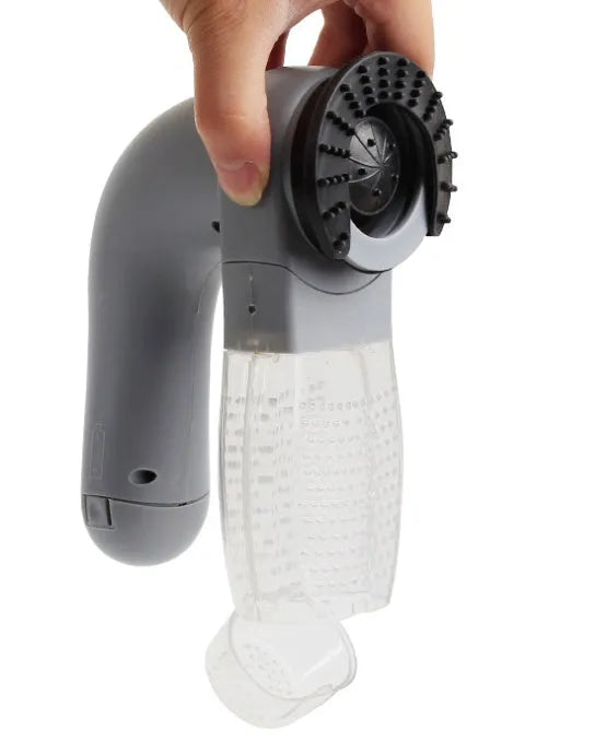 Grey handheld electric pet hair remover and massaging brush with soft rubber head.
