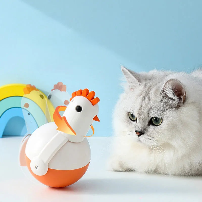 Green and orange electric cat toy chicken with laser and sound features on a flat surface.