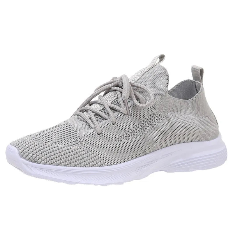Women's mesh running shoes in creamy white with Flyknit upper and round toe design