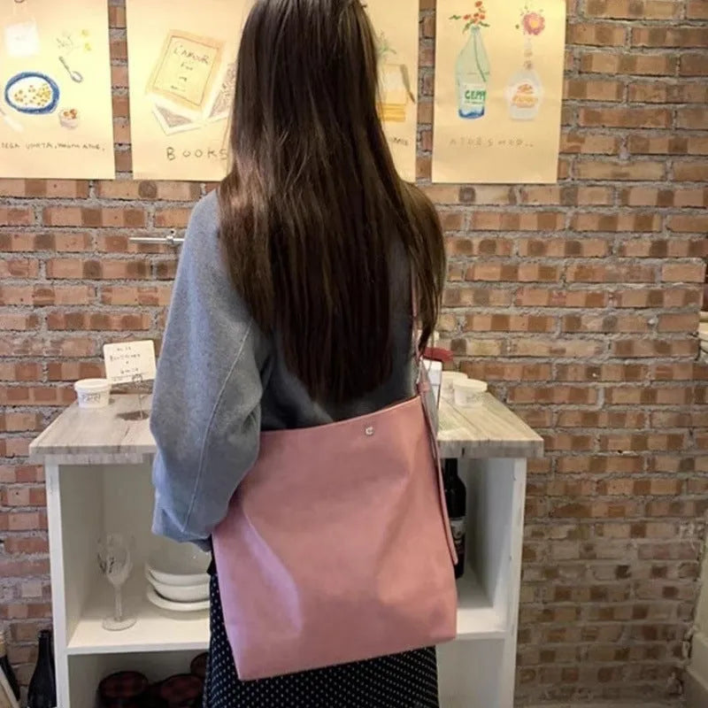 Pink and brown corduroy one-shoulder commuter bag with PU lining.