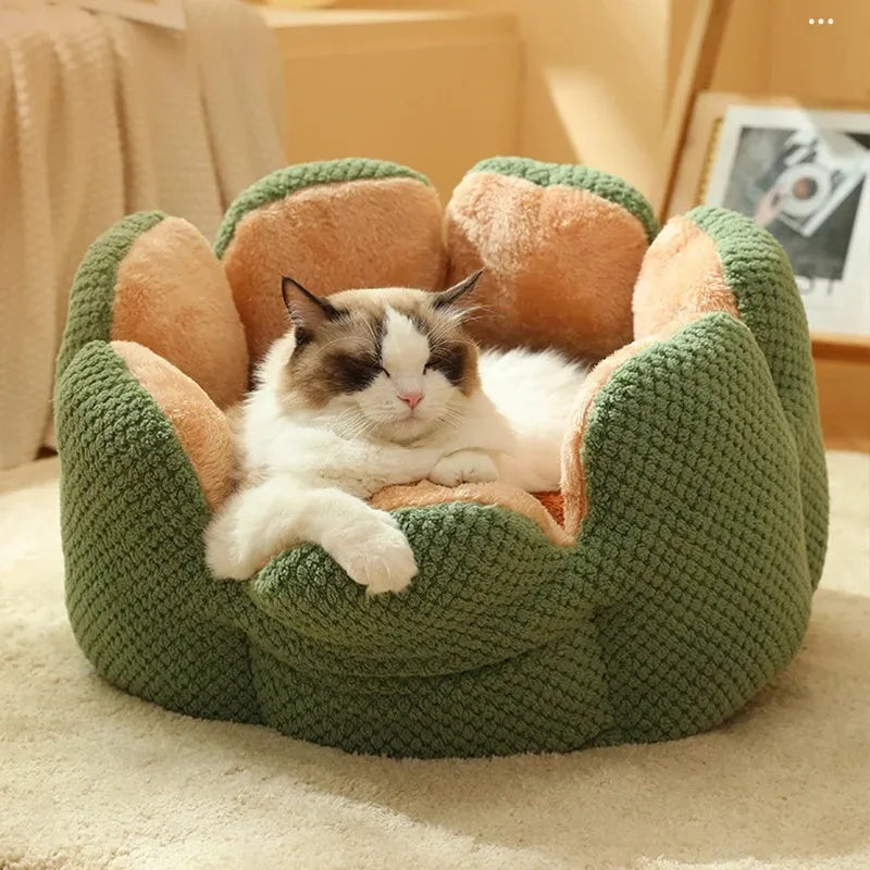 Green cactus petal shaped enclosed plush bed for a cat or small dog on a hardwood floor.