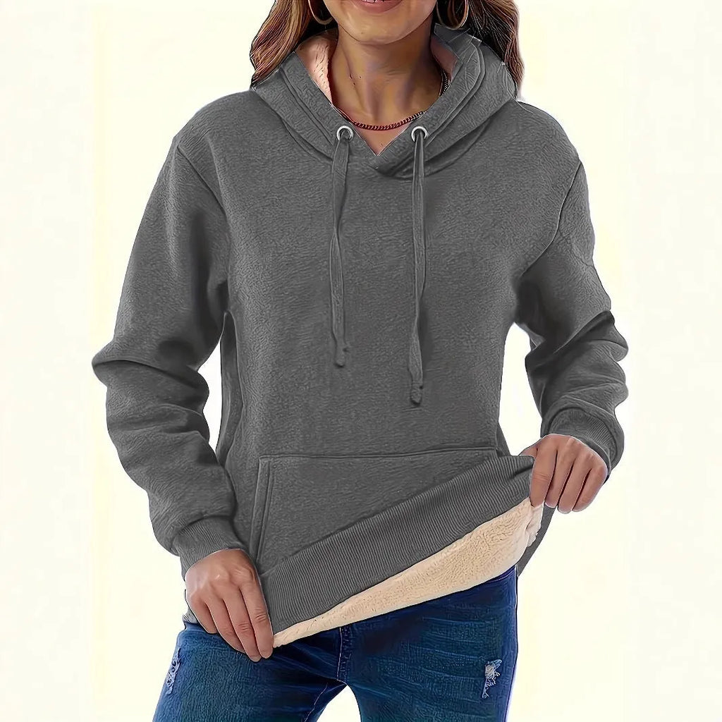 Women's loose black hooded sweater with pockets and a 3D textured pattern, long sleeves.